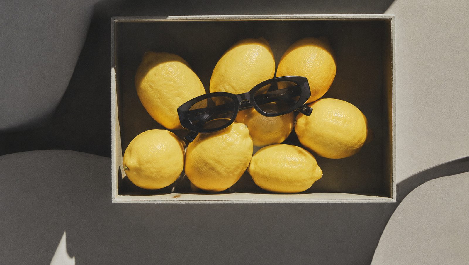 Lemons and sunglasses in a box